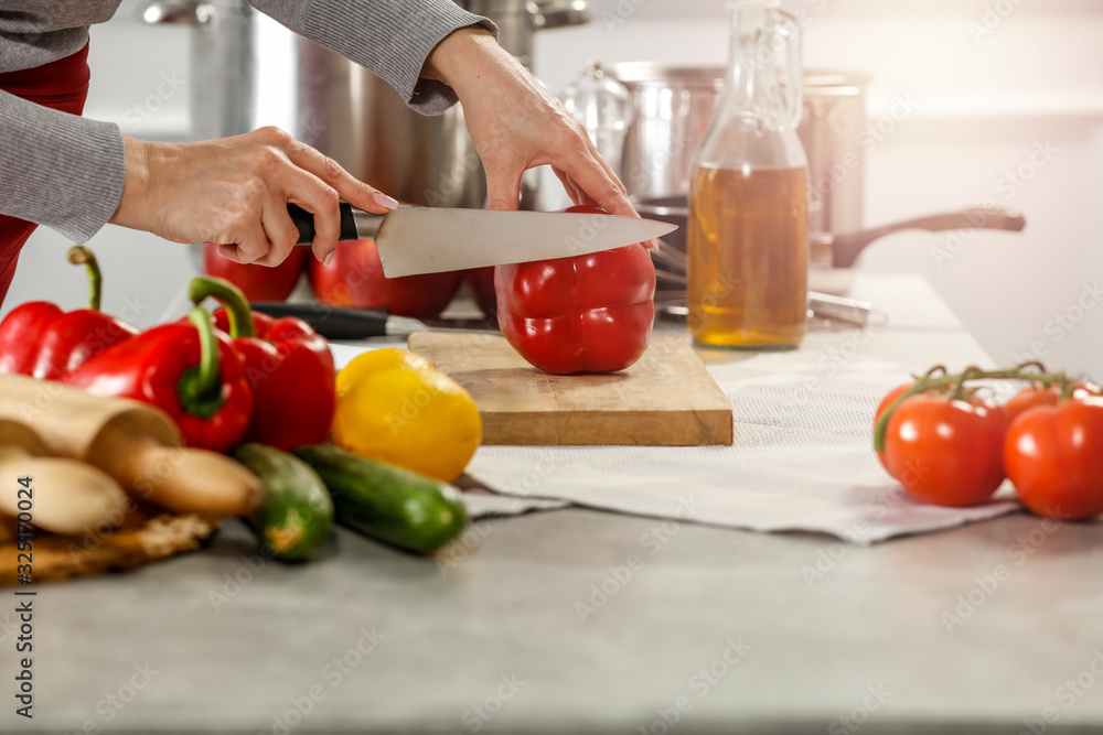 Hands in kitchen making meal.Table of free space for your decoration and fresh vegetables. Hands in kitchen making meal.Table of free space for your decoration and fresh vegetables.