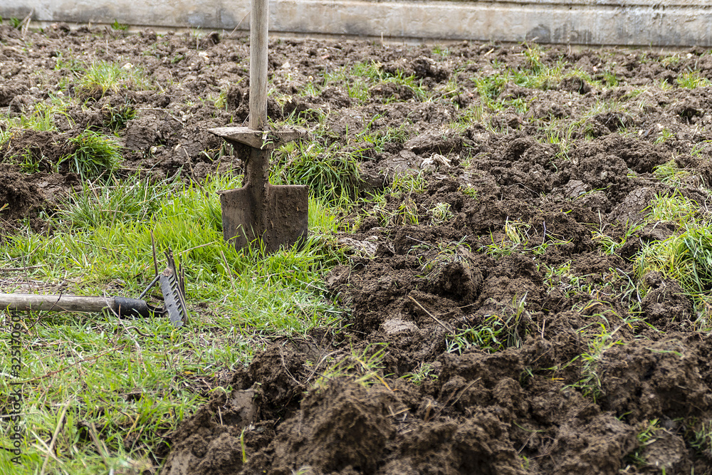 Fototapeta premium months of spring tillage, garden rake and shovel,