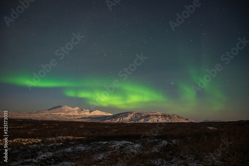 Northern lights above the glaciers in Iceland  © Peter Maszlen