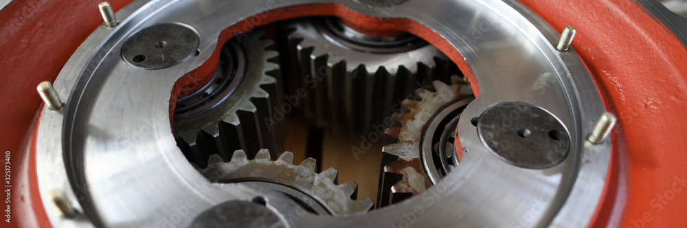Big mechanical gear part with set of cogwheels inside close-up Big mechanical gear part with set of cogwheels inside close-up