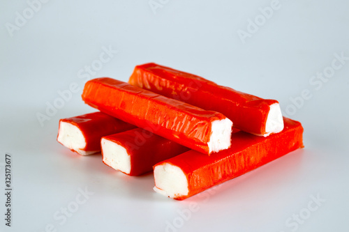 Frozen crab sticks shot on a light background. Background for food and ingredients. photo