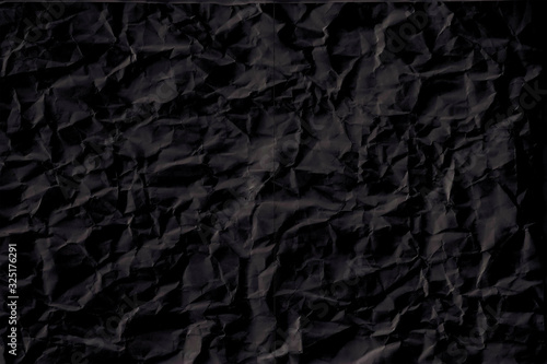 black crumpled paper texture with folds  black background  wallpaper.
