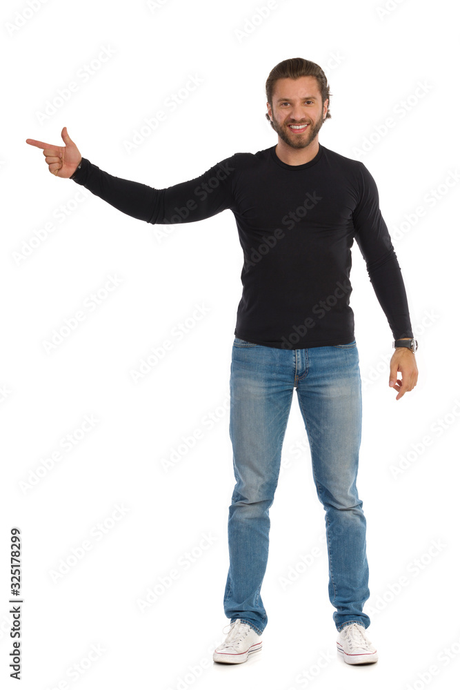 Confident Man Is In Black Blouse, Jeans And Sneakers Is Directing Confident Man Is In Black Blouse, Jeans And Sneakers Is Directing