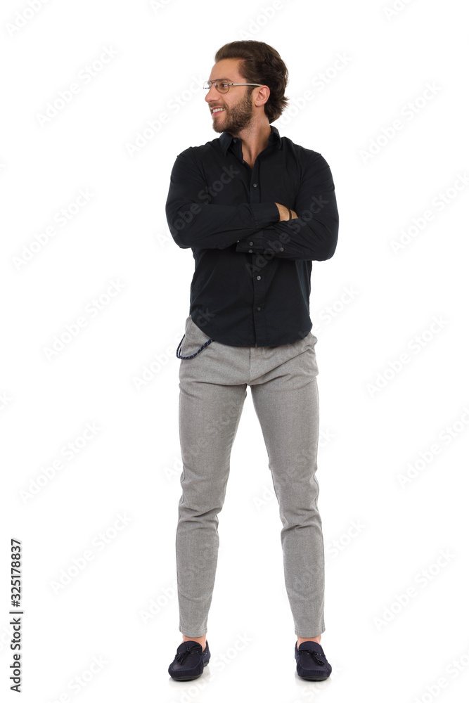 Confident Elegant Man Is Standing With Arms Crossed And Looking Away. Front View. Confident Elegant Man Is Standing With Arms Crossed And Looking Away. Front View.