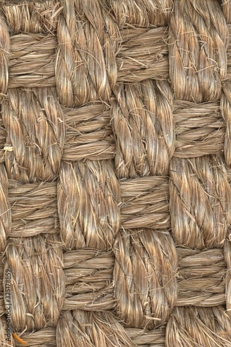 natural woven seagrass basket fibers close up texture with brightlight