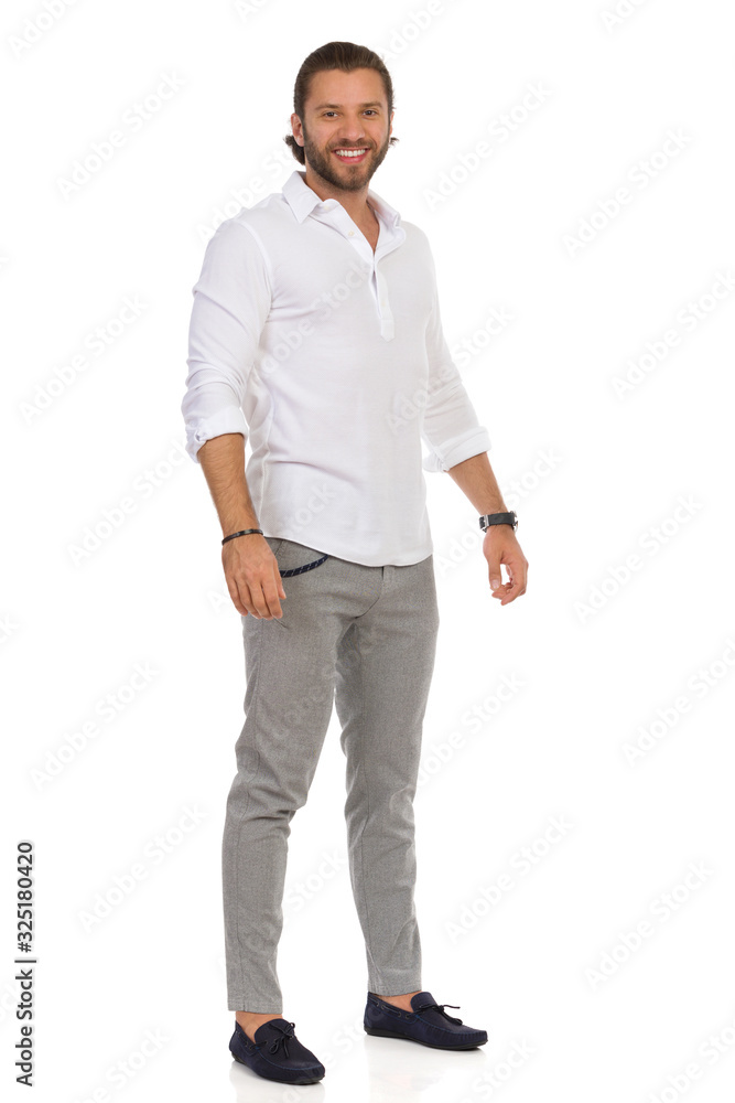 young man standing with his hands in pockets young man standing with his hands in pockets