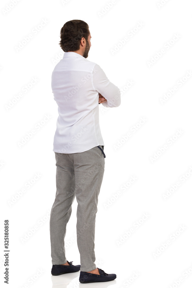 Elegant Man Standing With Arms Crossed And Looking Away. Rear View. Elegant Man Standing With Arms Crossed And Looking Away. Rear View.