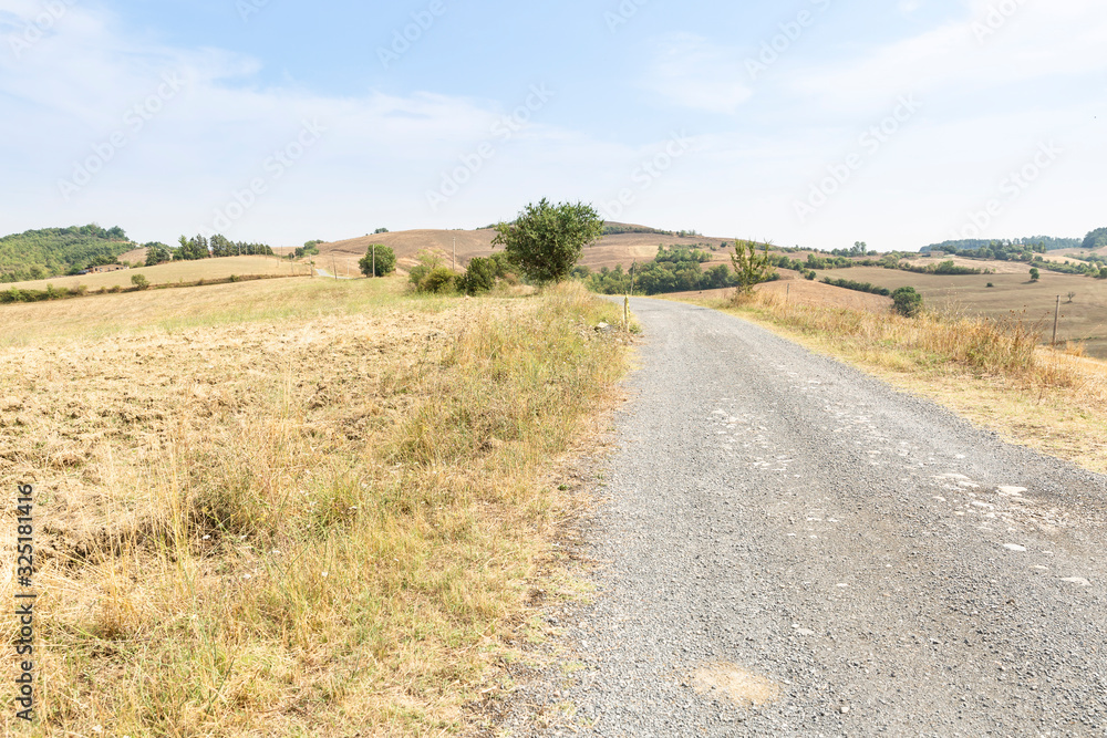 a gravel road through agricultural fields next to Proceno, Province of Viterbo, Lazio region, Italy a gravel road through agricultural fields next to Proceno, Province of Viterbo, Lazio region, Italy
