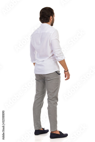 Elegant Man Standing Relaxed. Rear View.