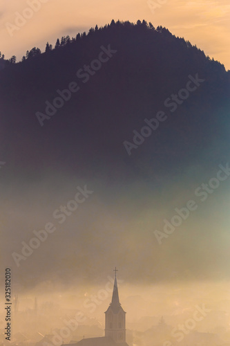 Church silhouette misty village landscape seen from above