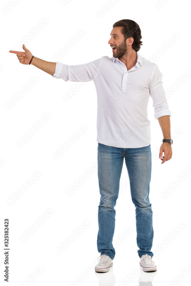 Young Man Is Standing, Pointing At Te Side And Talking Young Man Is Standing, Pointing At Te Side And Talking