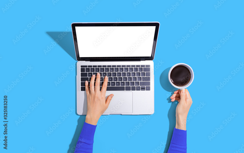 Person using a laptop computer from above Person using a laptop computer from above