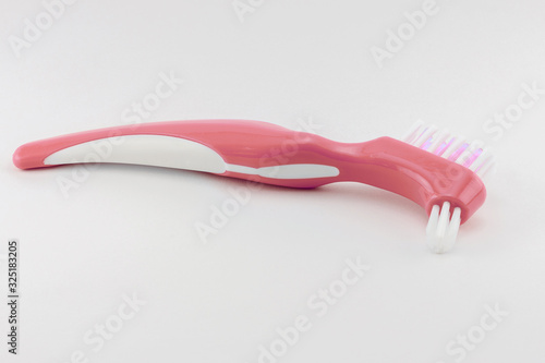 hard brush for cleaning and rinsing removable dentures  care and treatment of plastic dentures daily at home