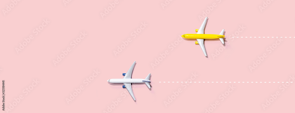 Fototapeta Flights booking and reservation theme with two miniature airplanes