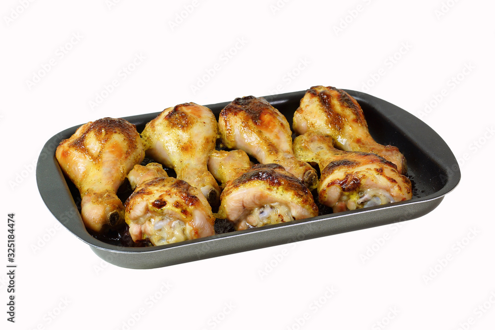 Fried chicken legs on a baking sheet. Isolated Fried chicken legs on a baking sheet. Isolated