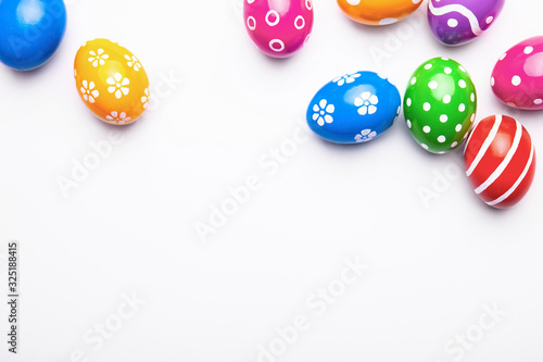 Flat lay composition made with Easter eggs on light background. Top view with place for text