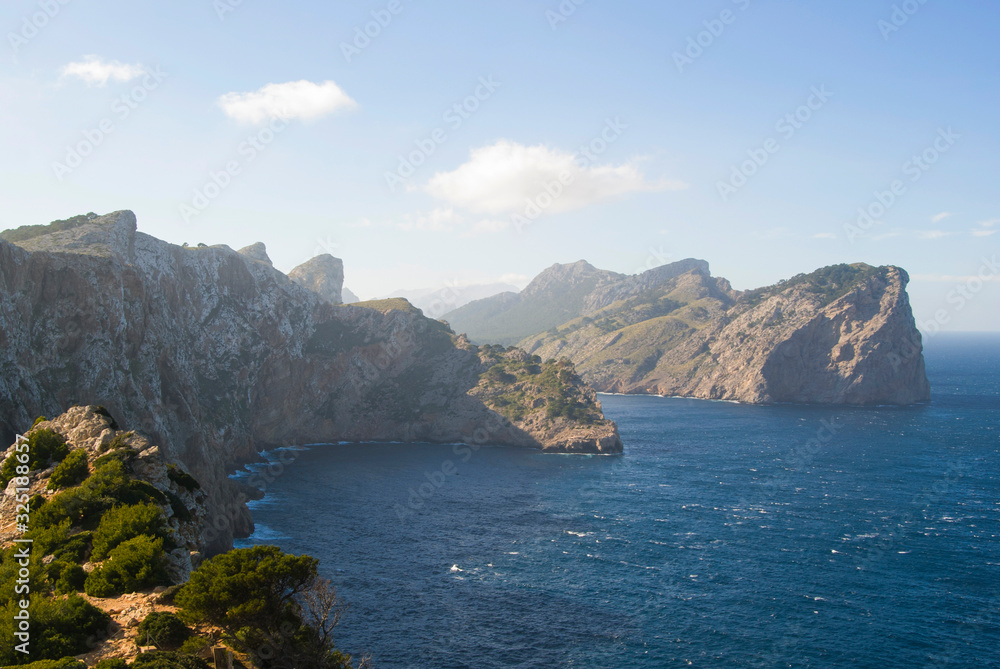 Beautiful scenery on the coast of Majorca. Sea and rocks covered with green forests. Majorca, Spain