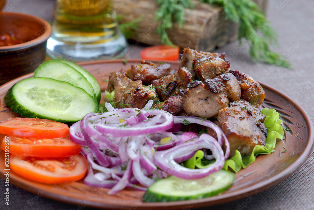pork skewers with a side dish of vegetables pork skewers with a side dish of vegetables