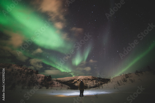 woman i the grat outdoors and Northern lights