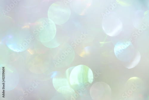 Delicate white glitter bokeh background. Creative and moody color of the picture.