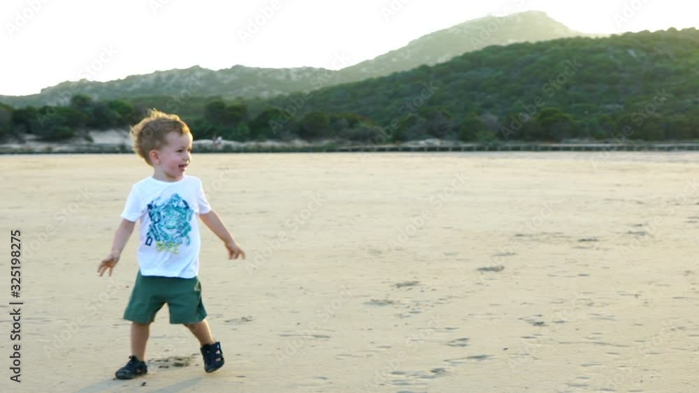 Little boy having fun and trying to flying kite on the beach, slow motion Little boy having fun and trying to flying kite on the beach, slow motion
