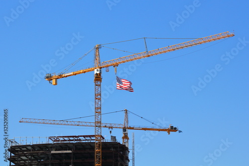 American Flag, proudly flying over a building under construction