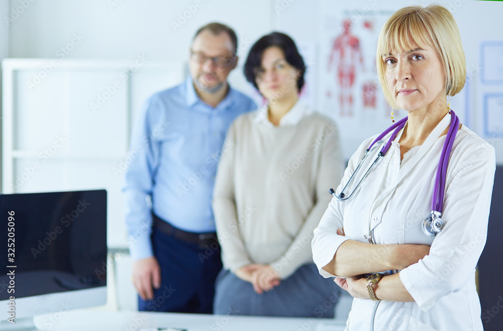 Smiling medical doctor with stethoscope and elderly couple Smiling medical doctor with stethoscope and elderly couple