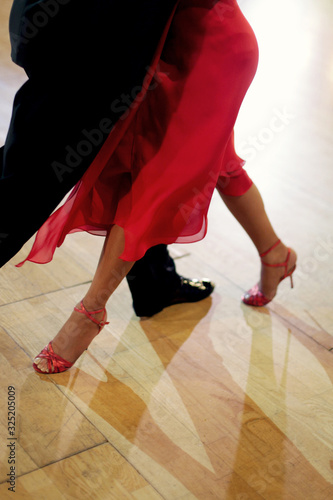 Beautiful woman in red dress dancing Argentinian tango 