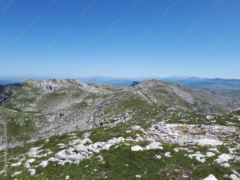 Mountain panorama with rocks, meadows and distant mountains	