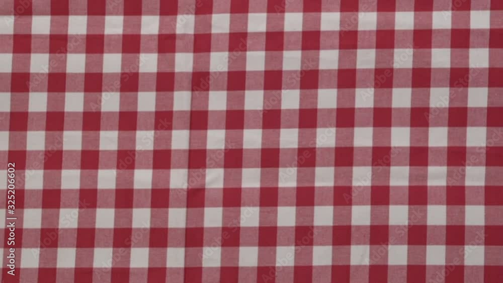 While the wooden table is covered by the red-white checkered tablecloth, the top view. Stock Video While the wooden table is covered by the red-white checkered tablecloth, the top view. Stock Video