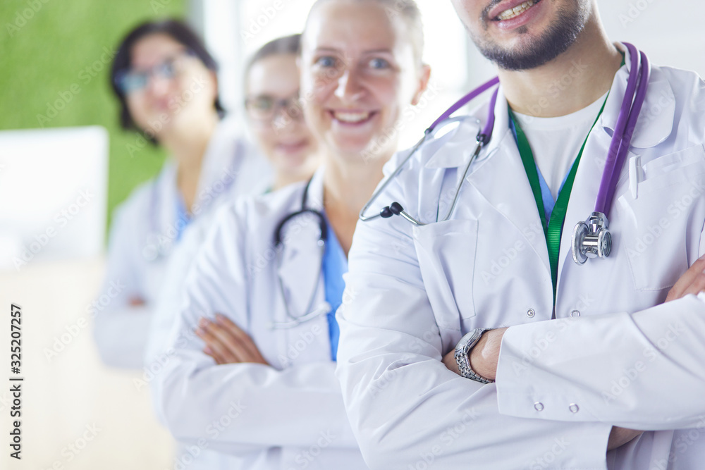 Group of doctors and nurses standing in the hospital room Group of doctors and nurses standing in the hospital room