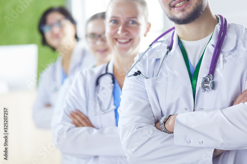 Group of doctors and nurses standing in the hospital room