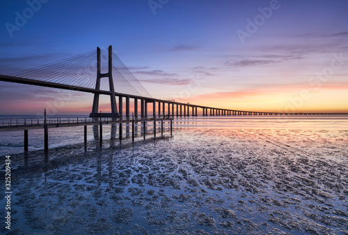 Vasco da Gama Bridge and pier over Tagus River in Lisbon, Portugal, before sunrise.  © p_rocha