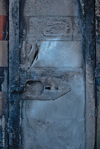 Burned european ambulance door closeup arson in Schoneberg Berlin Germany photo