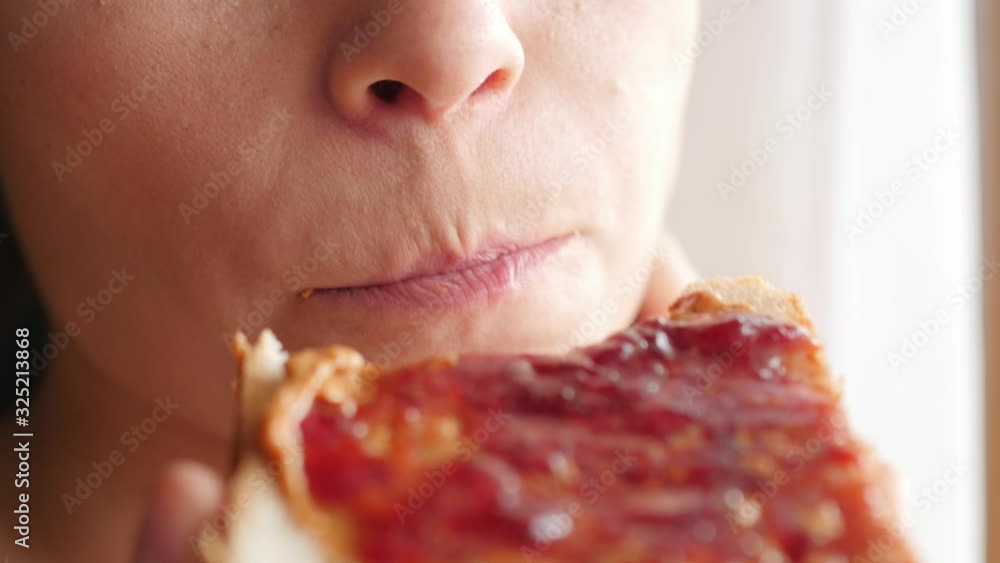 eating peanut butter and jelly, jam sandwich, closeup, macro eating peanut butter and jelly, jam sandwich, closeup, macro