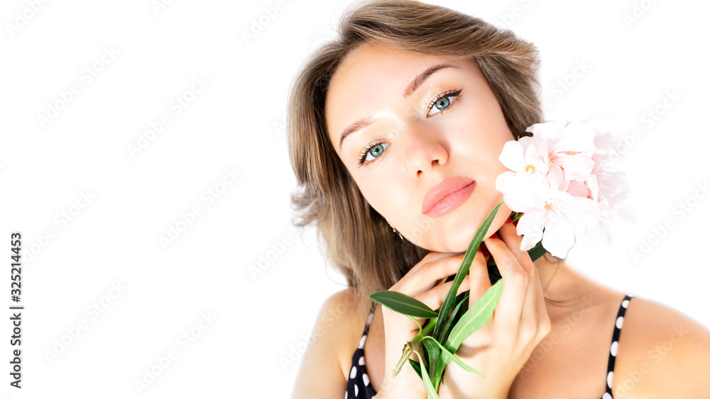 Young beautiful female woman with make-up, plump lips, clean skin and flowers isolated on white background. Pure fresh skin, lip plumping concept. Copy space.