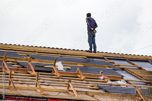 Roof worker during roof replacement