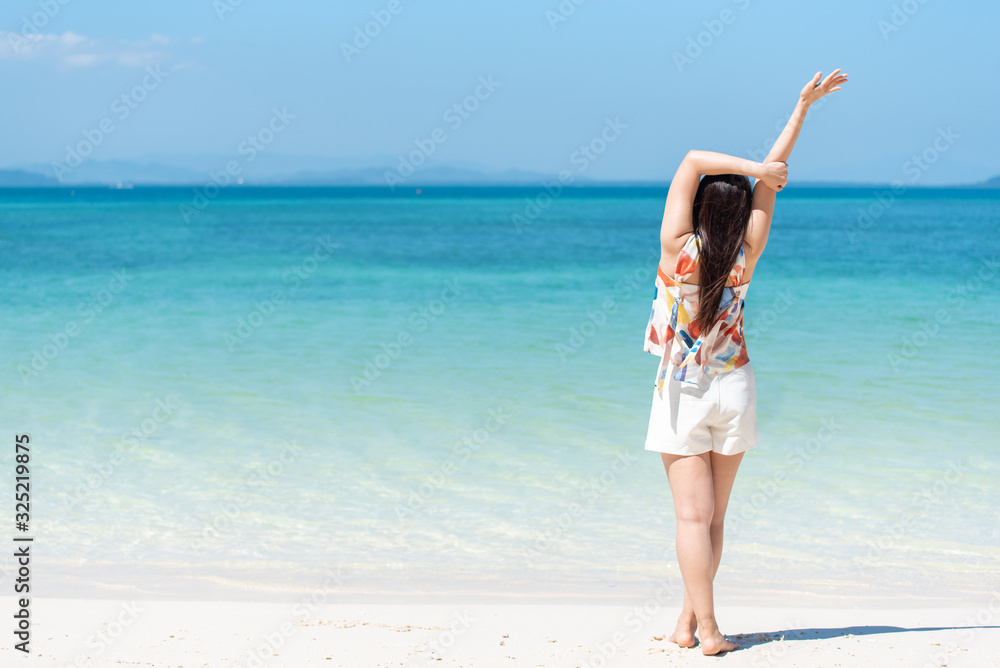 Happy Asian woman relaxing body on white beach with copy space Happy Asian woman relaxing body on white beach with copy space