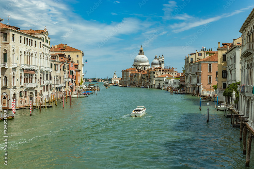 VENICE, ITALY - August 02, 2019: Grand Canal with Basilica di Santa Maria della Salute in Venice, Italy. View of Venice Grand Canal in sunny day. Architecture and landmarks of Venice