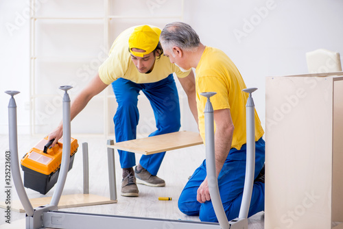 Two contractors carpenters working indoors