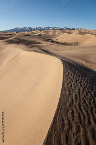 Gobi Desert Singing Sand Dunes mountain at background