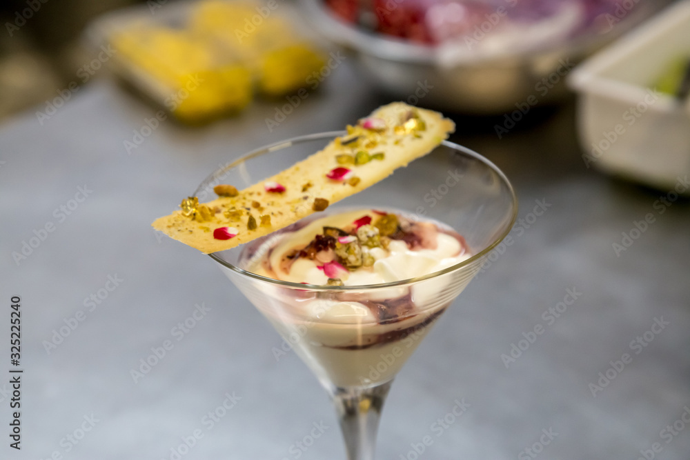 dessert in a martini glass with yogurt cookie and gold dust dessert in a martini glass with yogurt cookie and gold dust