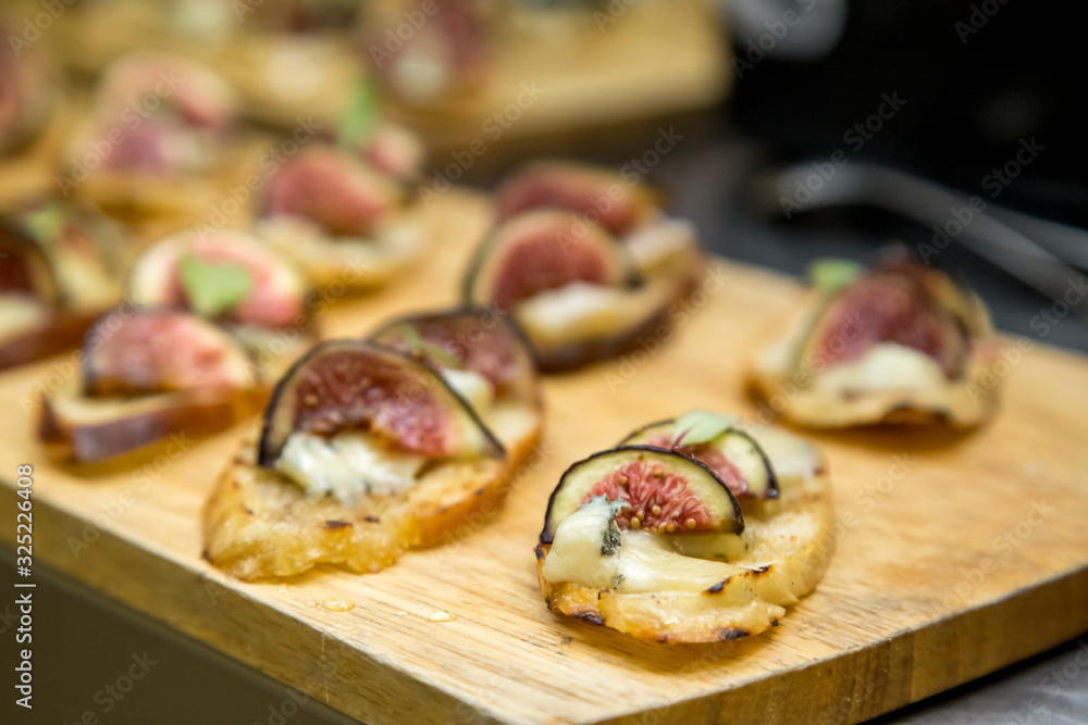 toast with brie cheese and figs on a wooden board