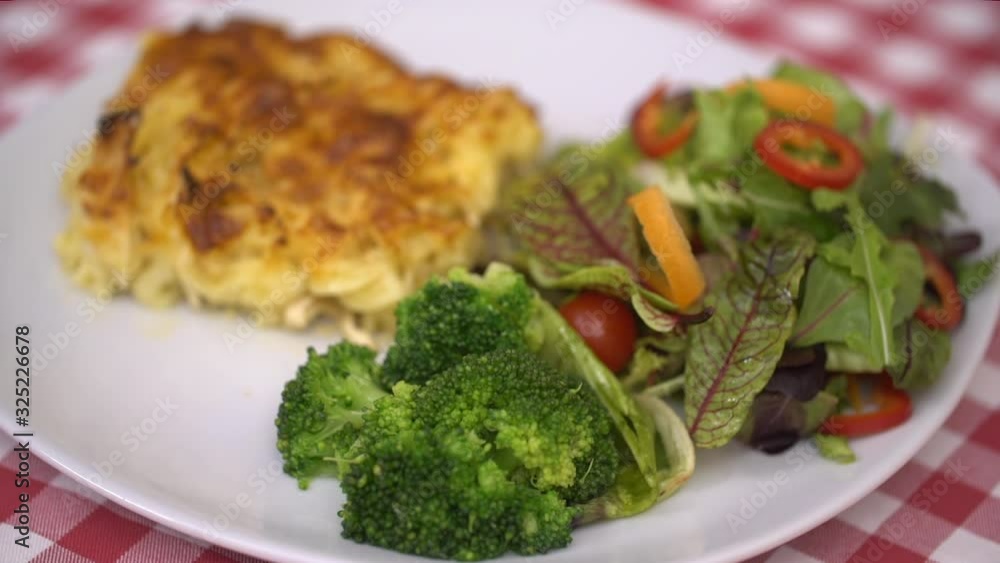 Chef is presenting ready to eat chicken alfredo, on checkered tablecloth background, closeup stock video Chef is presenting ready to eat chicken alfredo, on checkered tablecloth background, closeup stock video