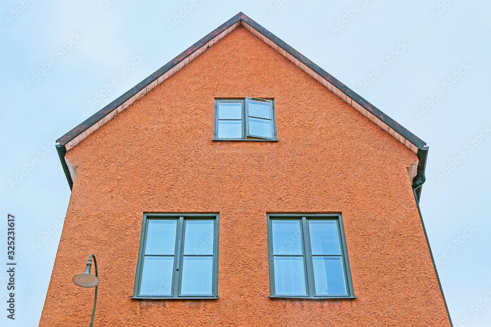 exterior facade of old orange building in visby sweden