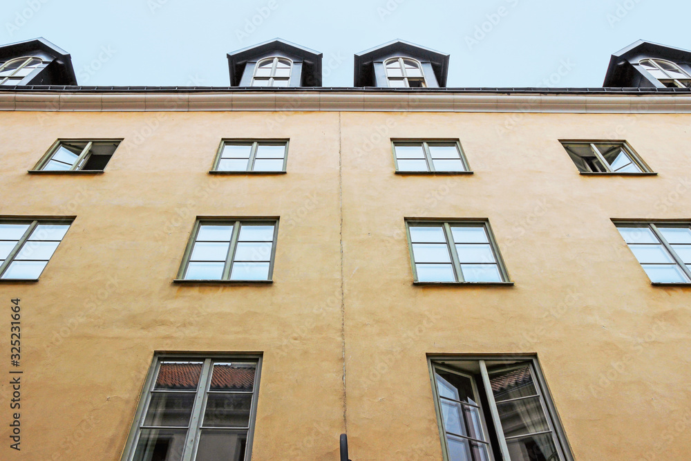 Fototapeta premium exterior facade of old orange building in visby sweden