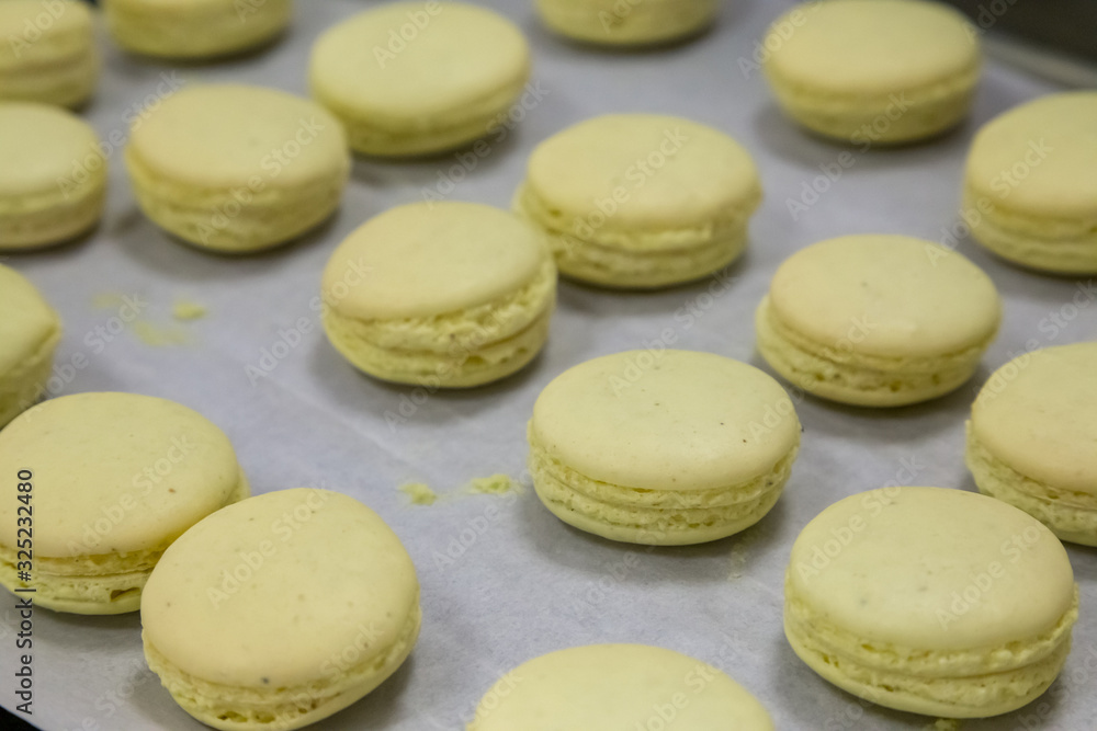 Fototapeta premium yellow macaroons on a tray