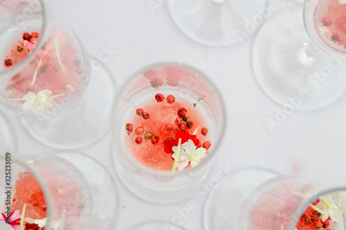 glasses with watermelon red peppercorns and flowers