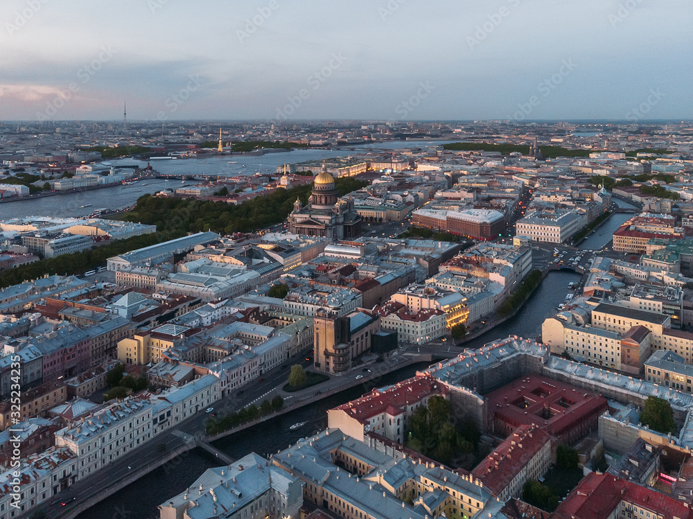 Aerial view of St. Isaac's Cathedral, Peter and Paul Cathedral and rooftops of Saint Petersburg. View from above on Moyka and Neva river. Evening light. Drone photo concept. Orthodox church.