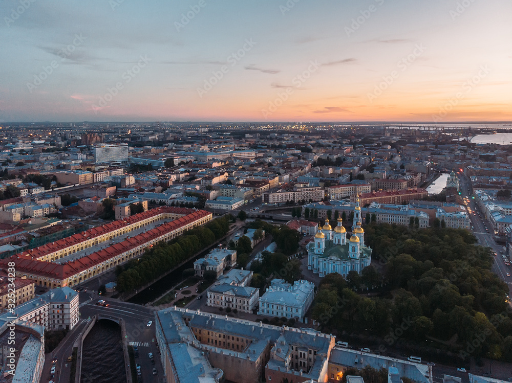 Aerial view of St. Nicholas Naval Cathedral in Saint Petersburg. View from above on Moyka. Evening light. Drone photo concept. Sunset sky. St Petersburg most famous city in Russia. Orthodox church.